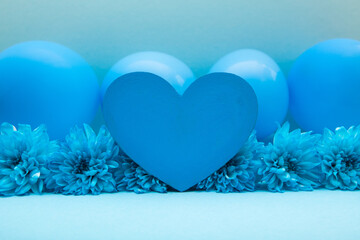 Blue heart with flowers and air balloons on the light blue background, creative card