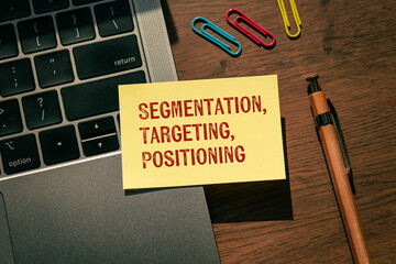 There is sticky note with the word Segmentation, Targeting, Positioning. It is as an eye-catching...
