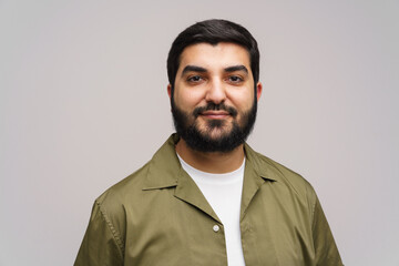Capturing a confident portrait of a young man dressed in casual attire against a neutral backdrop