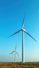Giant wind turbines rotating against a blue sky, wind farm, clouds