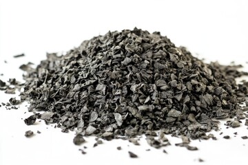 Dark gray, finely-crushed particles piled in a mound against a white background
