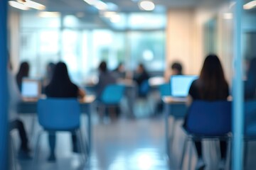 Blurry indoor scene of people working in a modern study area