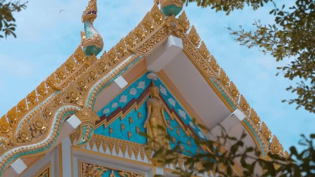Amazing Ayutthaya-style dragon-like gilded chofahs and elements of the roof of Wat Na Phra Meru Buddhist temple in Ayutthaya province, Thailand. Shot in motion