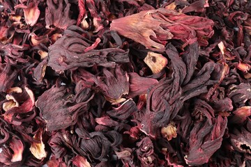 Hibiscus tea. Dried roselle sepals as background, top view