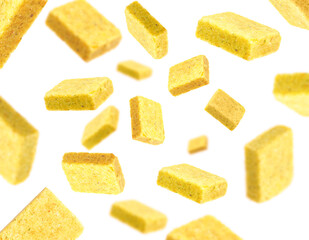 Bouillon cubes in air on white background