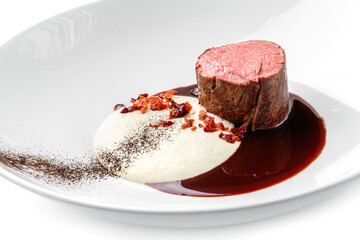 Grilled fillet mignon steak or grilled beef medallion with sauce on plate isolated on white background. Meat dishes, top view, close up