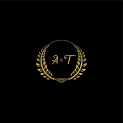 Naklejka premium AT beautiful, feminine and elegant wedding monogram initial logo with circle floral gold