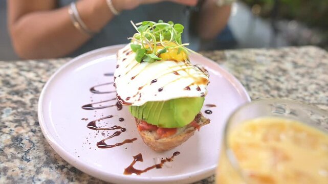 Close-up of a slice of avocado toast with egg for breakfast.