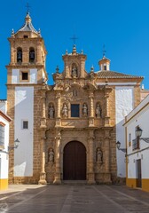 Fototapeta premium Photo of Ornate Stone Church Facade Under a Clear Blue Sky in Spain