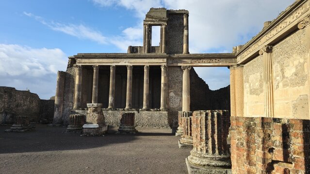 Pompeii, Italy - 8 January 2025. Ruins of the Basilica in Pompeii, Italy, with rows of stone columns and partial walls, once used for legal and business matters in the Roman Forum.