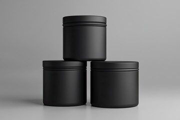 Three matte black cylindrical containers stacked in a pyramid on a light gray background