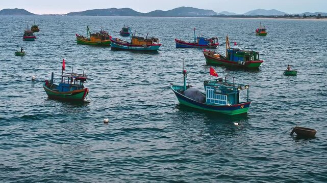 Traditional wooden Vietnamese fishing boats and ships at sea at the port in Vietnam
