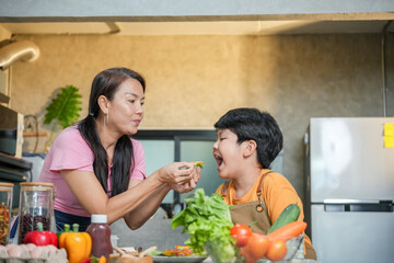 Cheerful Asian Mother and Son Cooking Together at Home, Parent and Child Enjoy Cooking Time at Home