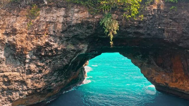 Travel people explore beautiful Bali destination Broken Beach Nusa Penida with beautifu natural pool in form crater and scenery stone bridge on nature background. , Bali, Indonesia. 4K Aerial view