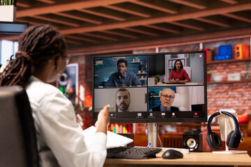 Employee talking with coworkers during videocall from home desk, organizing calendar appointments. Worker preparing for corporate event, doing remote teleconference meeting with colleagues