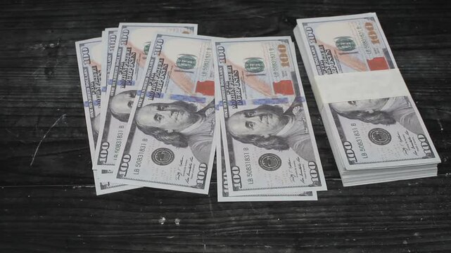 some dollar bills scattered on the black table