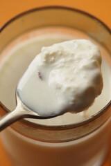 spoon pick cream from a milk glass 