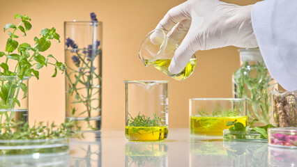 Pouring vivid green botanical solution into a glass beaker with test tube setup and leafy herbs in...