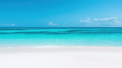 Fototapeta premium Crystal clear turquoise water gently laps the shore of a pristine white sand beach on a perfect summer day