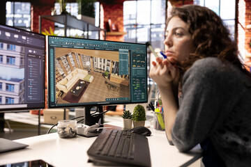 Young woman editor uses digital interface to design an apartment floor plan, working on a 3D modeling project. Architectural software enables professional rendering and virtual home configuration.