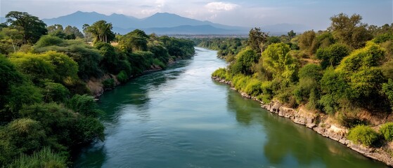 Serene river valley with distant mountains