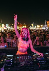 Photo of DJ Performing at Outdoor Music Festival with Crowd and Lights