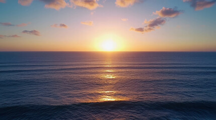 Obraz premium Stunning Sunset Over Calm Ocean Waves at Dusk, Vibrant Colors Reflecting on Water Surface, Tranquil Seascape with Peaceful Atmosphere