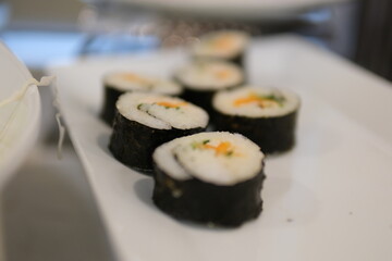 Rice roll filled with carrot, sausage, radish and egg. Kimbap Korean Rolls