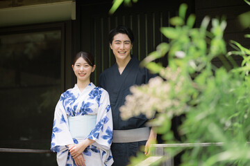 Camera-ready upper body of an image of a couple or couples in yukata on a hot spring trip or...