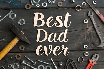 Photo of Best dad ever message surrounded by tools, including hammer and wrench on a dark wooden background for father's day