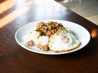 Pad Kaprao, Thai stir fried spicy minced pork with holy basil leaves, served with sunny side up egg, popular Thai local dish