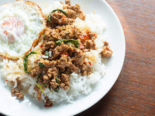 Thai spicy stir fried holy basil leaves with minced pork on rice, with sunny side up