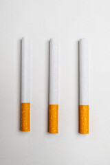 Cigarettes, rolled tobacco in paper with a filter tube, isolated on a white background. No or quit smoking, a bad habit, and unhealthy