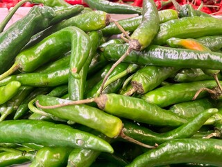 Fresh pile of green chili peppers in the market 