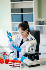 Discover a dedicated scientist conducting laboratory research, using pipettes, microscopes, and lab...
