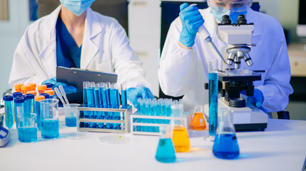 Two female biotechnologists testing new chemical substances in a laboratory.