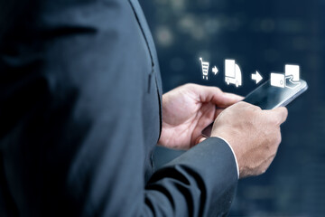 Businessman using a cellphone with ecommerce supply chain icon. Technology innovation on the virtual screen. Concept of industry, transport, and logistics