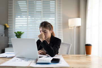 A stressed businesswoman sits alone in an office, overwhelmed by deadlines and corporate pressure,...