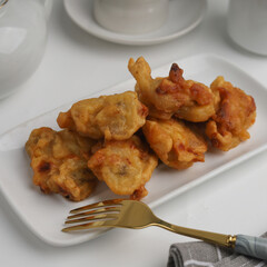 Banana fritters in a plate on white background