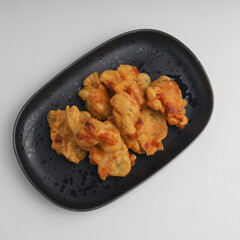 Banana fritters in a plate on white background