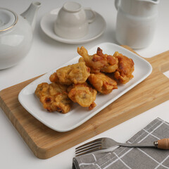 Banana fritters in a plate on white background