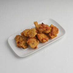Banana fritters in a plate on white background