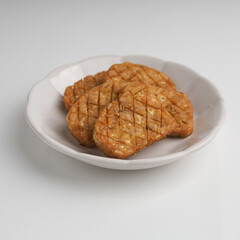 Fried tempeh on in a plate on white background
