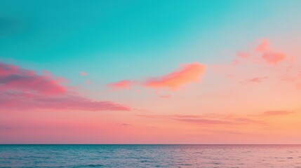 Naklejka premium Breathtaking sunset over a calm ocean, featuring a vibrant gradient sky in shades of pink and turquoise, creating a tranquil and colorful scene