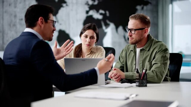Travel Agent Giving Information To A Young Couple