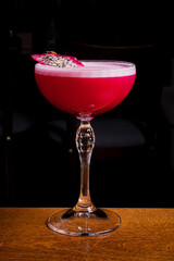 A colorful cocktail in a stylish glass, beautifully garnished for a night out