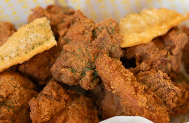 Close-up of deep-fried boneless chicken pieces with deep-fried glass noodle dumplings.