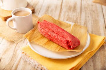 Sweet Tamale. hispanic dish typical of Mexico and some Latin American countries. Corn dough wrapped in corn leaves. The tamales are steamed. Usually accompanied with atole, hot chocolate or coffee