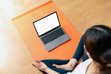 Woman doing exercise yoga plank and blank screen on laptop, for putting advertising to promote.