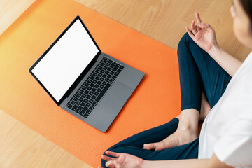 Woman doing exercise yoga plank and blank screen on laptop, for putting advertising to promote.